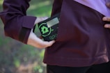Lifestyle image of a person using the gadget outdoors.