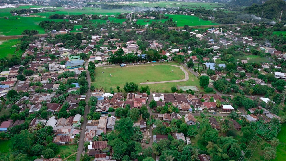 an aerial view of a small town with a soccer field