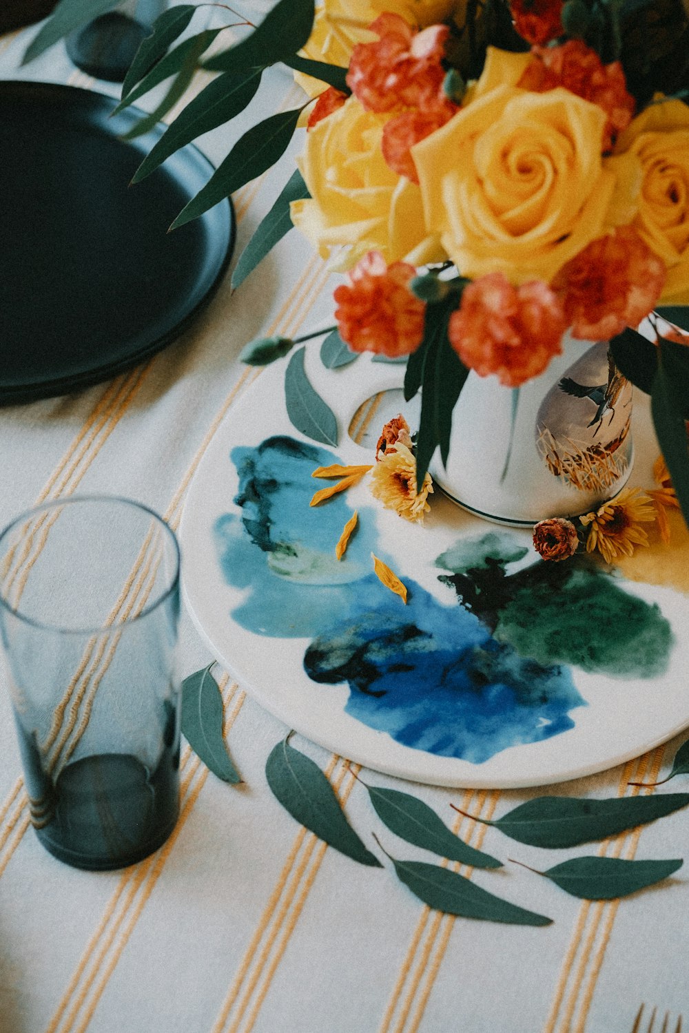 a plate with flowers on it sitting on a table