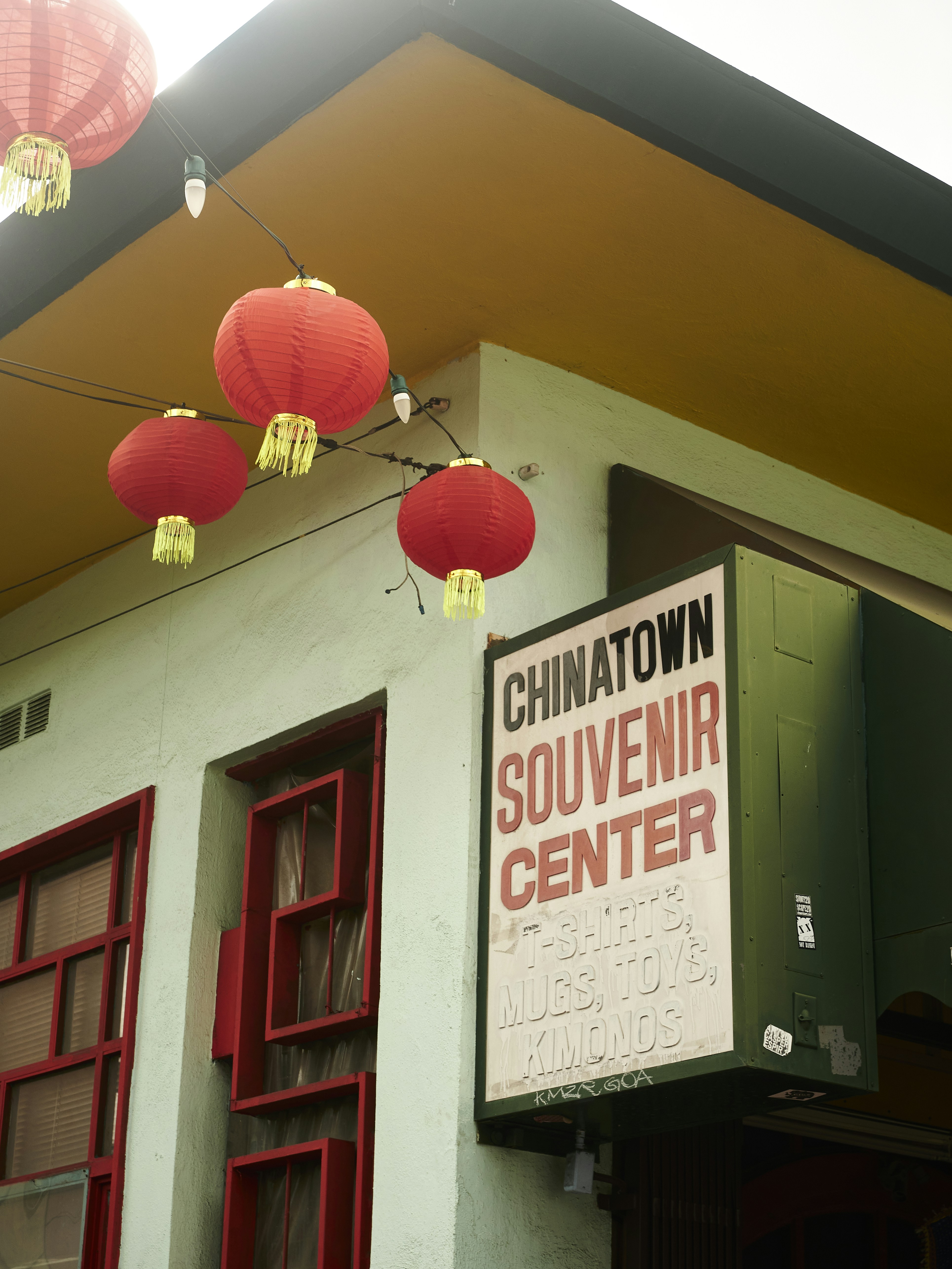 a building with red lanterns hanging from it's roof