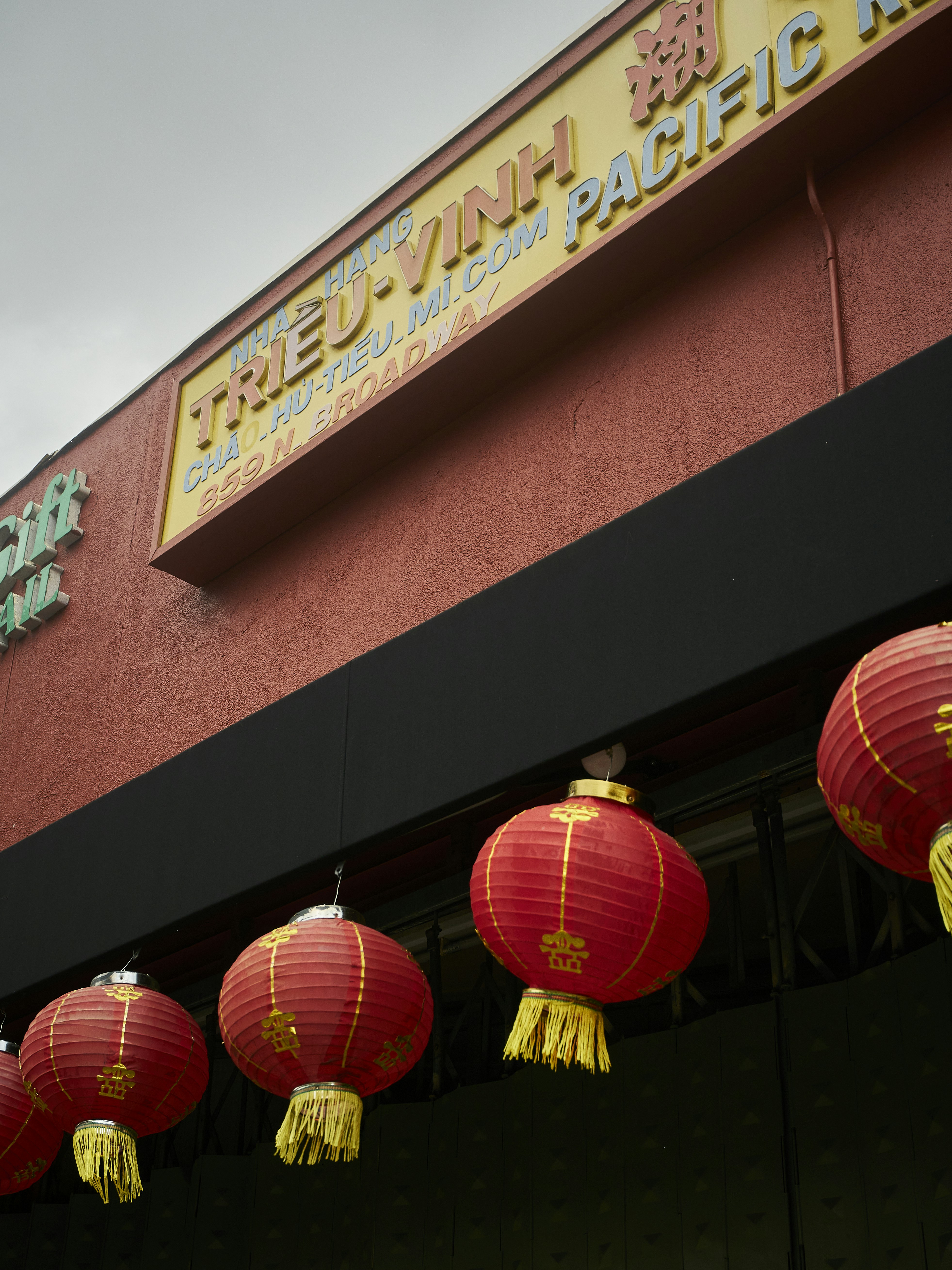 red lanterns hanging from the side of a building