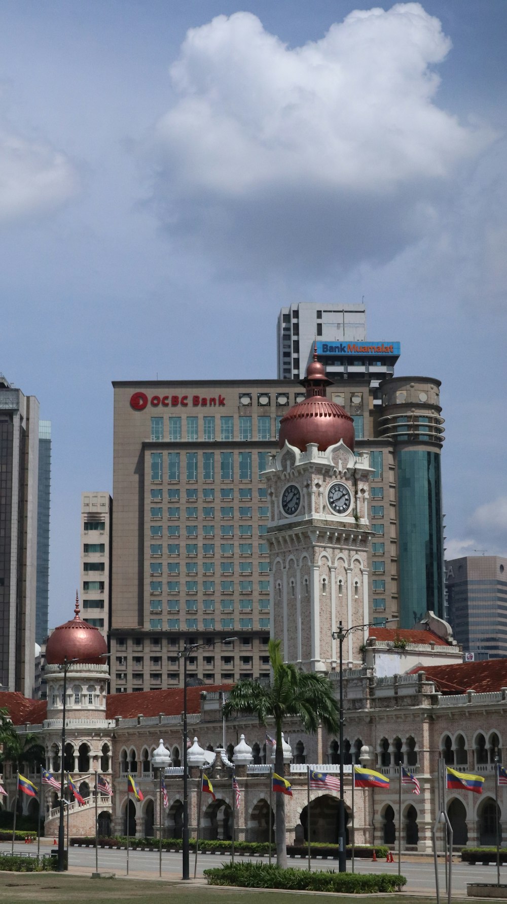 a large building with a clock tower in the middle of a city