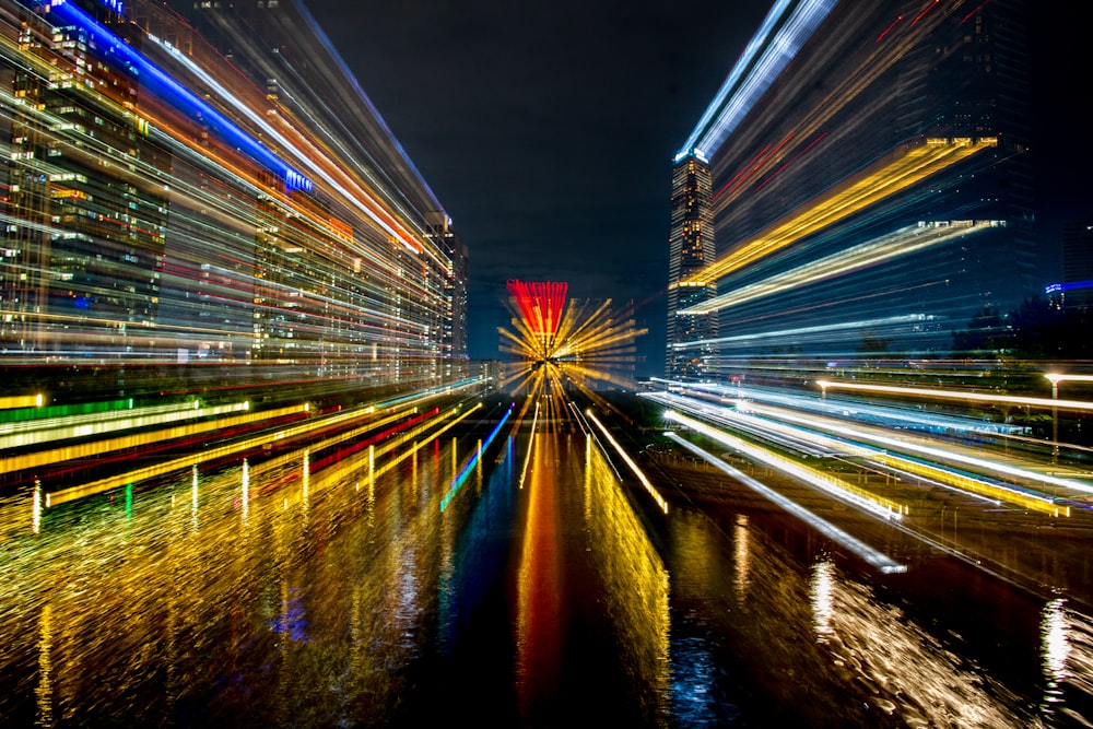 a city at night with lights reflecting in the water