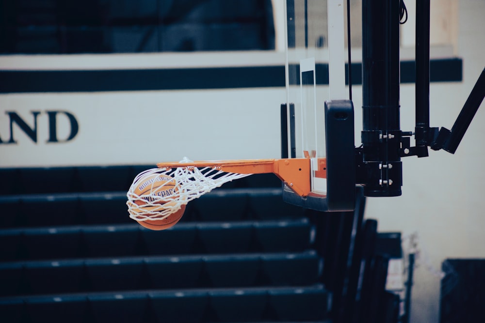a basketball going through the hoop in front of a bus