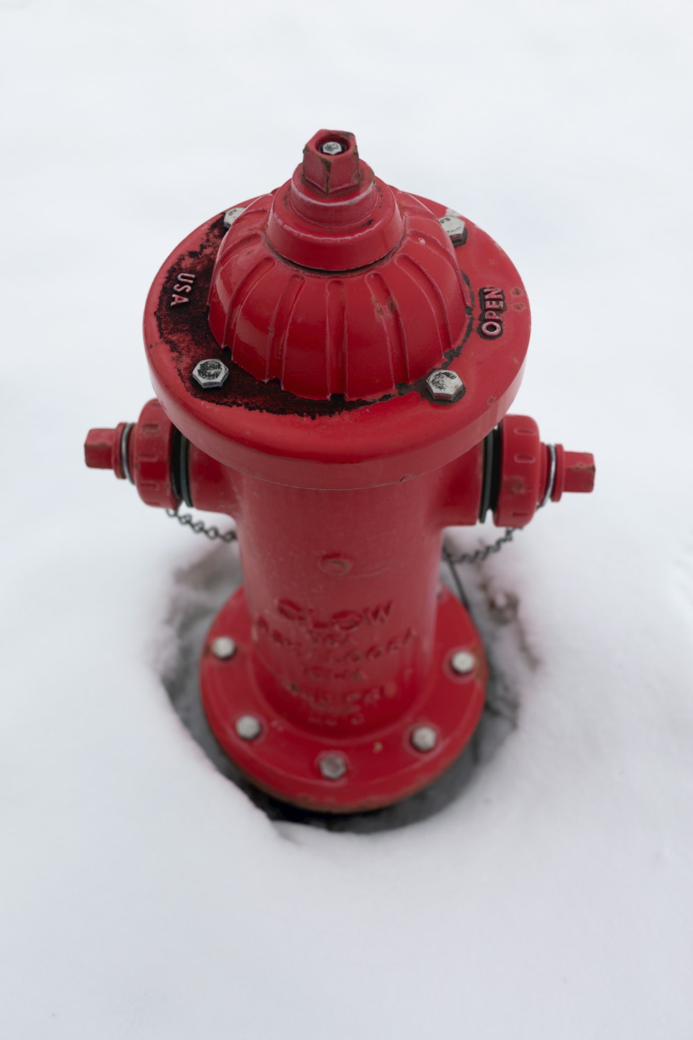 a red fire hydrant sitting in the snow