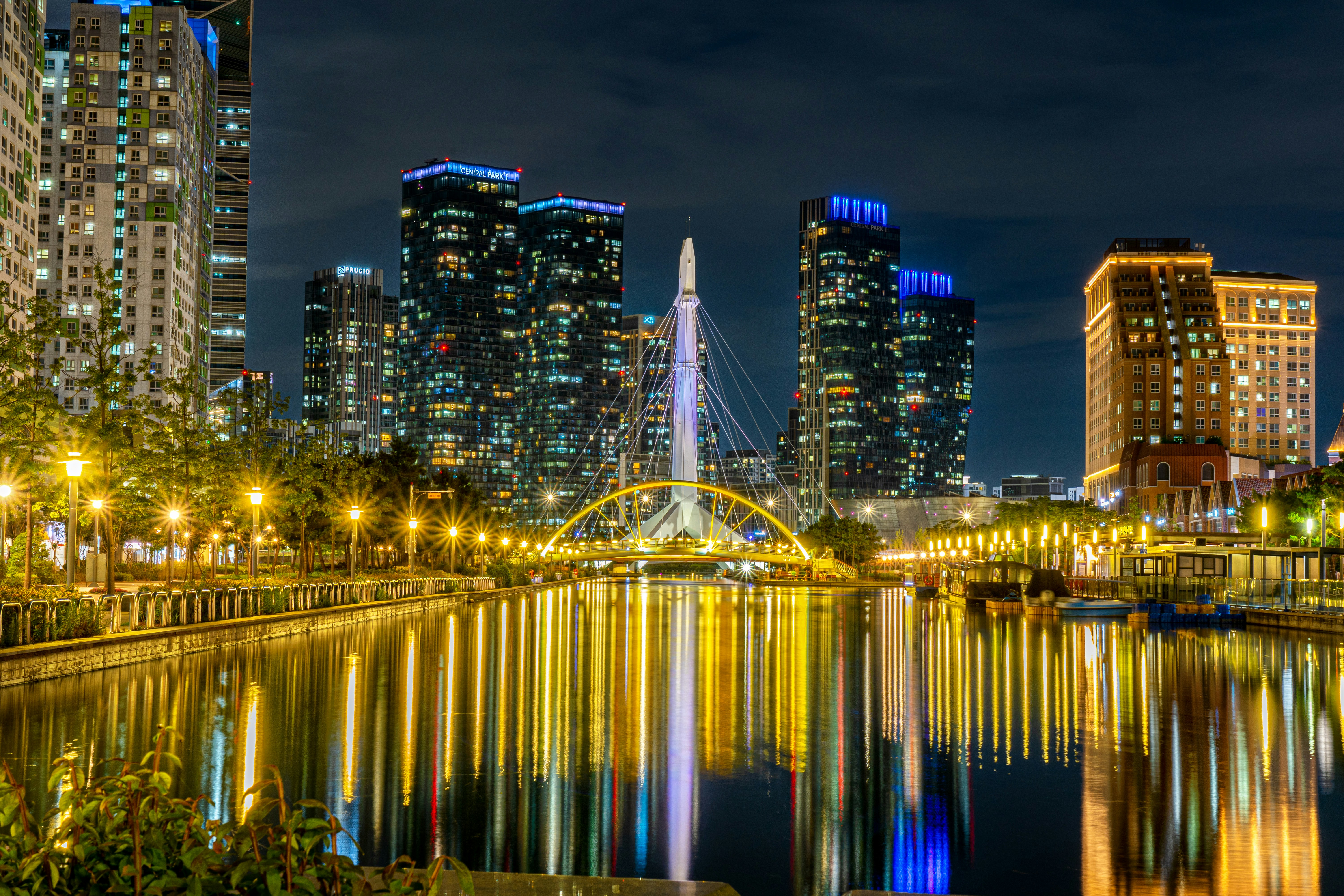 a city at night with lights reflecting in the water