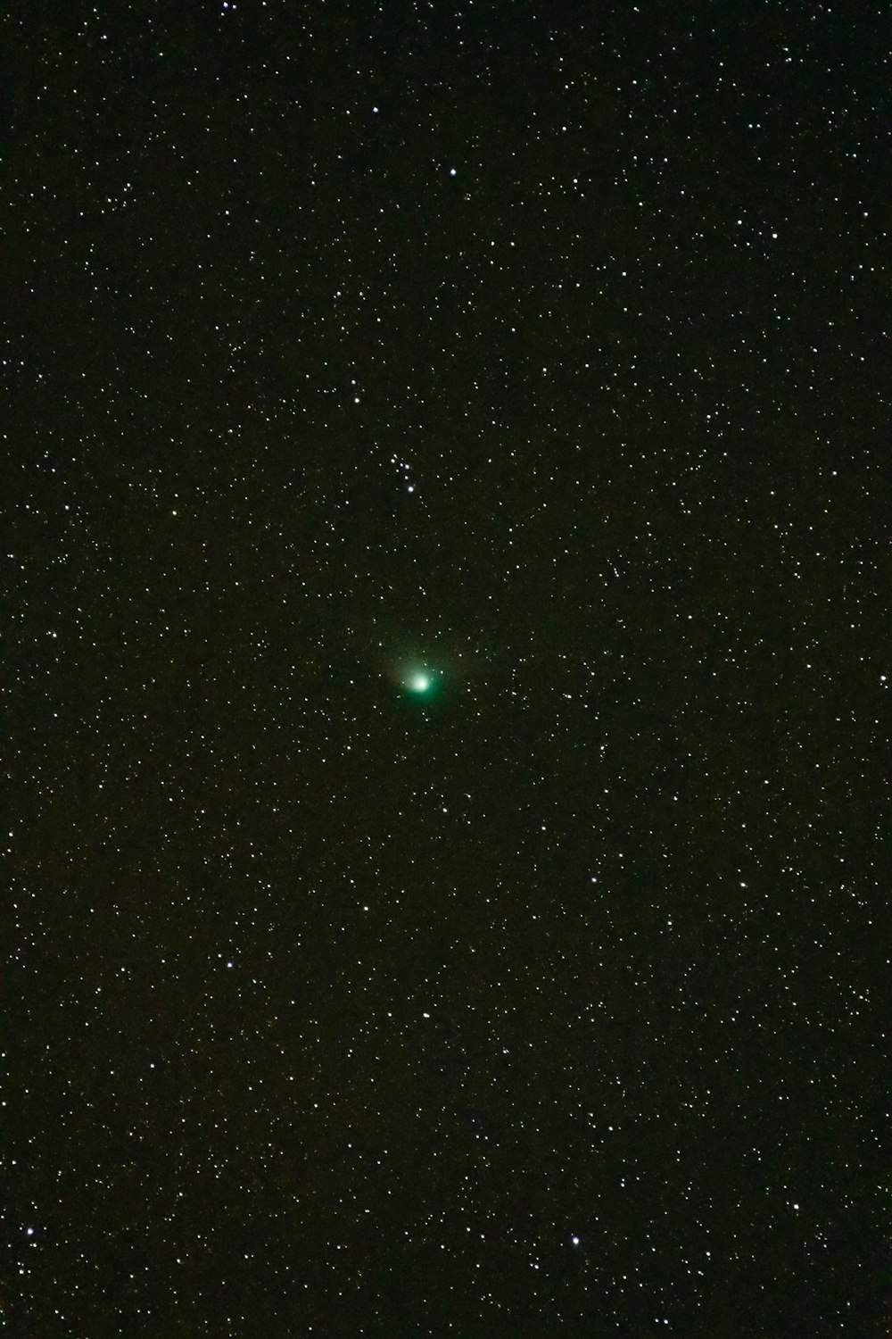 a green object is in the middle of the night sky