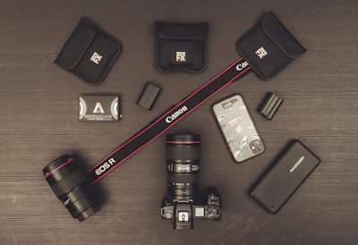 Stylish flat lay of photography and video equipment on a dark surface.