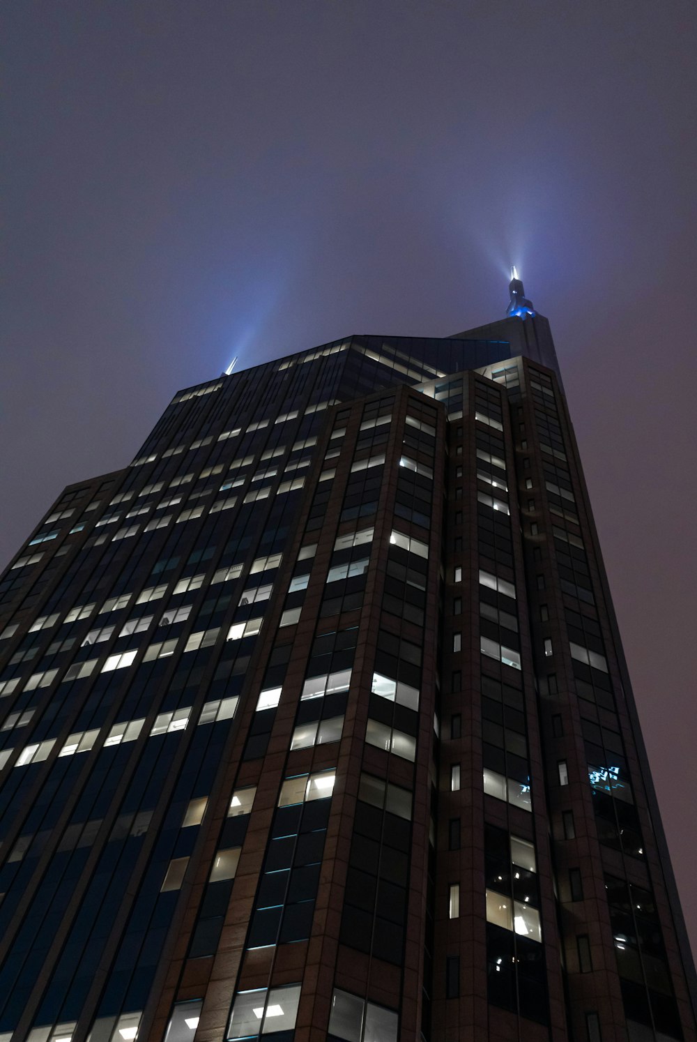 a very tall building with some lights on top of it