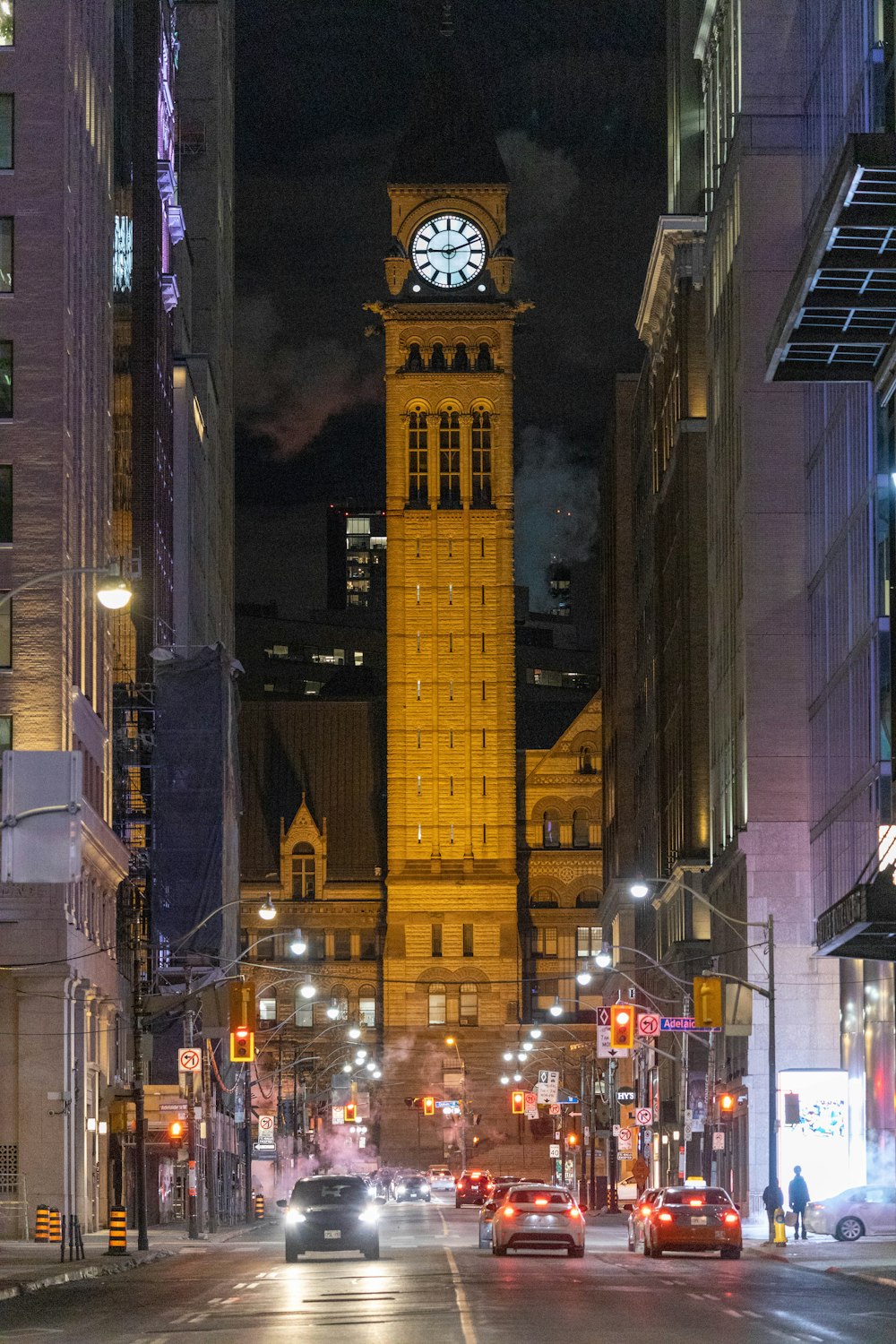 a large clock tower towering over a city at night