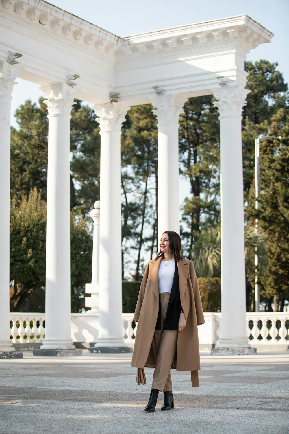 a woman standing in front of a white building