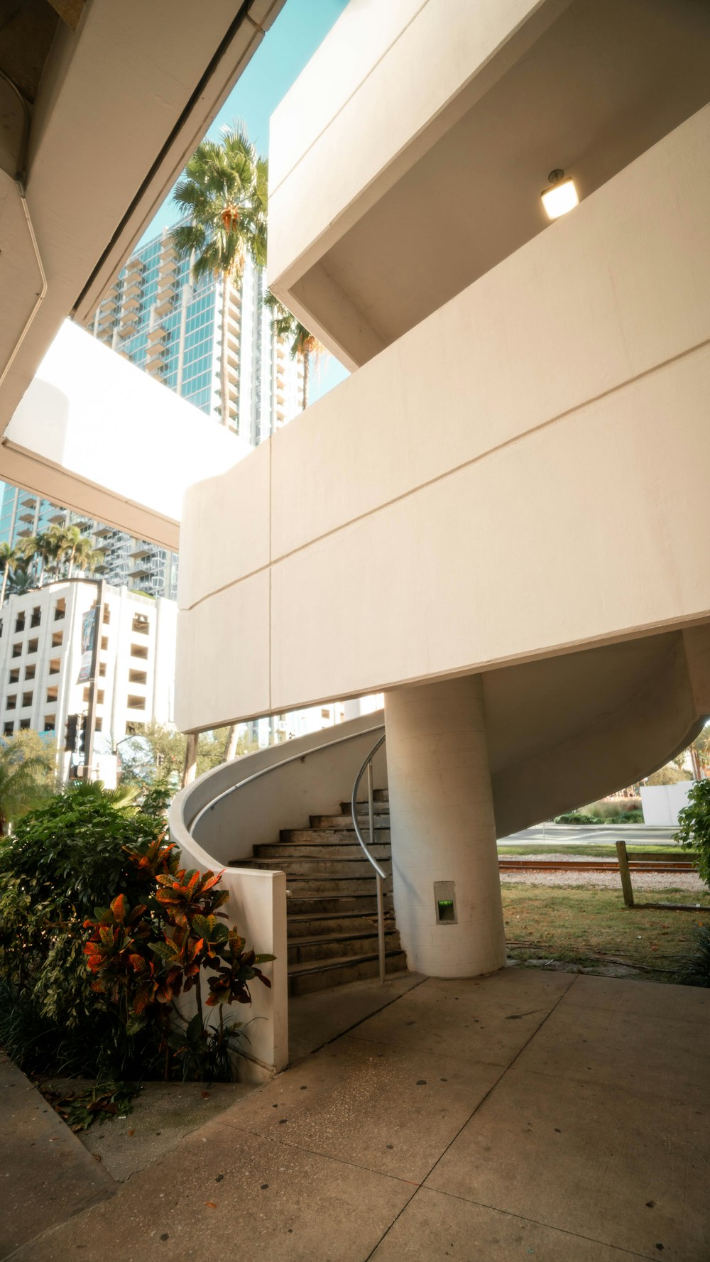 a staircase leading to a building with palm trees in the background