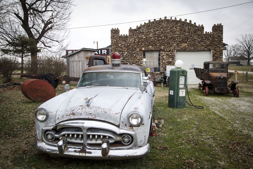 an old car is parked in front of a house