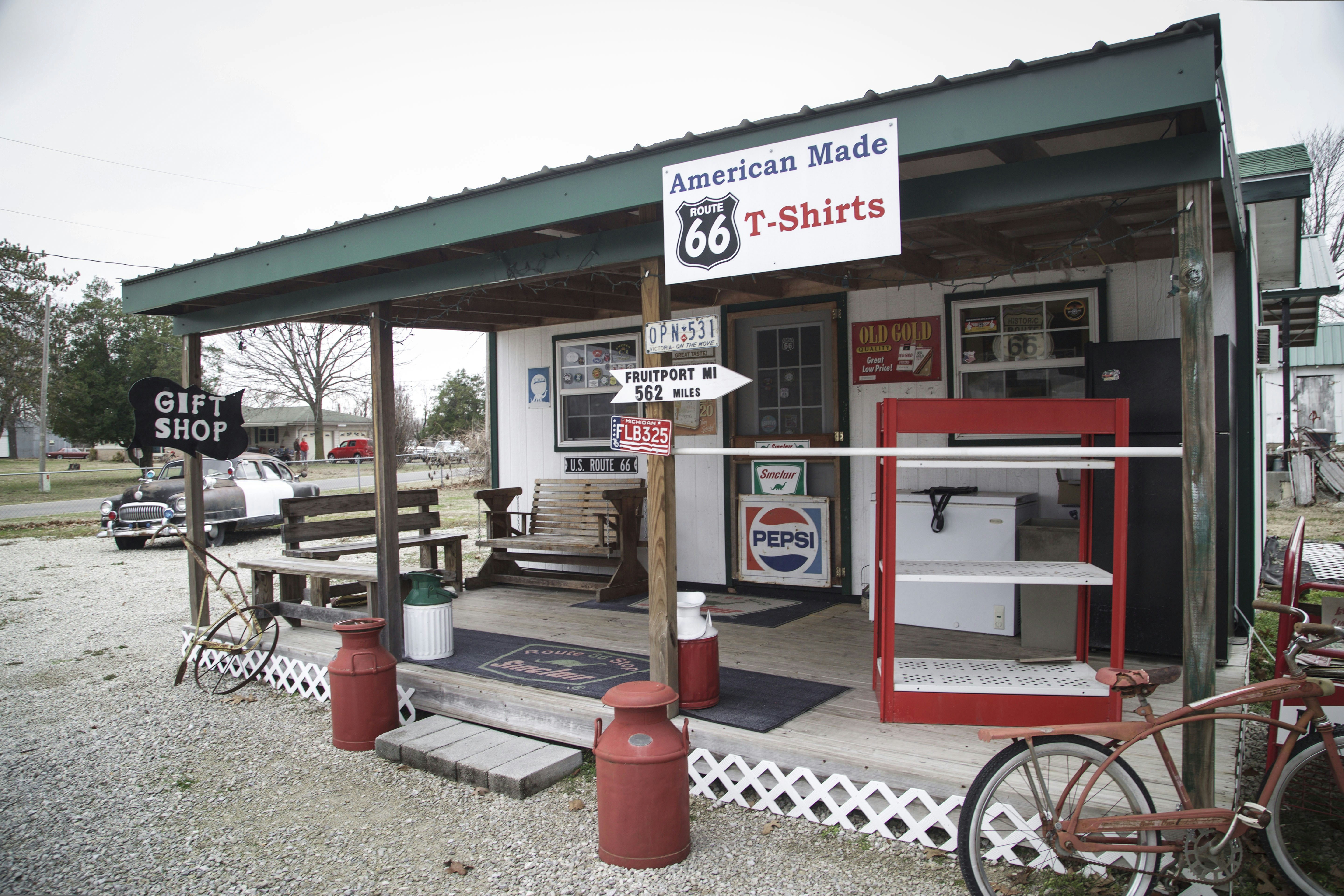 an old fashioned gas station with a bike parked outside, 
