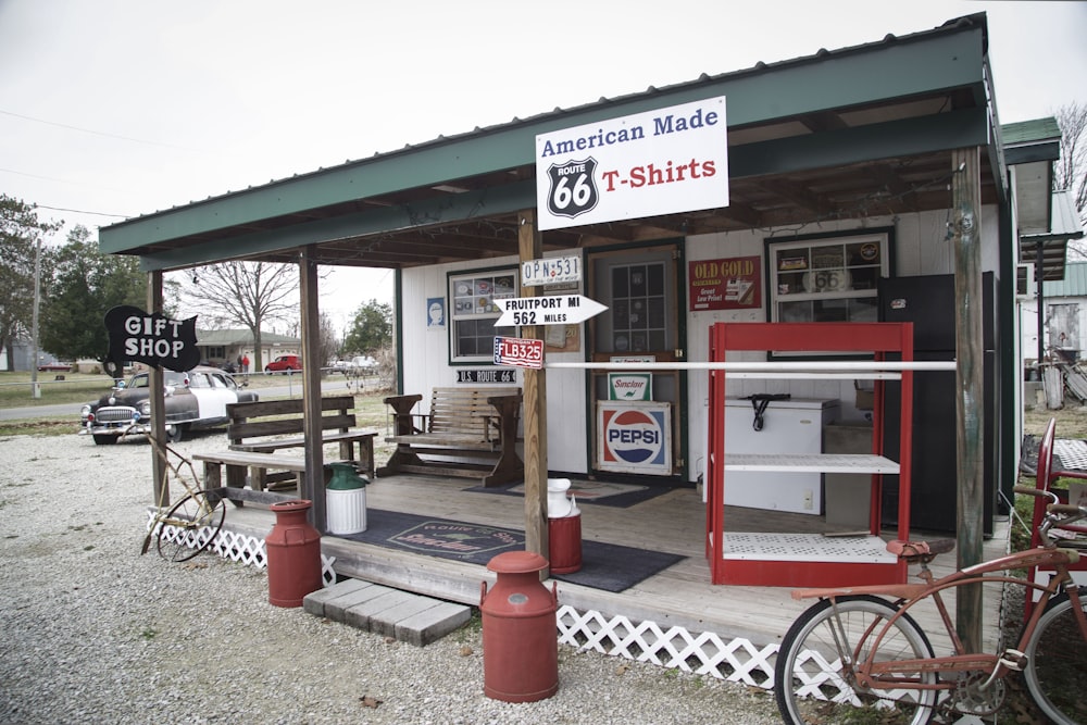 an old fashioned gas station with a bike parked outside