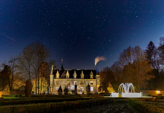 An elegant castle courtyard bathed in soft evening light, set for a luxurious wedding event.