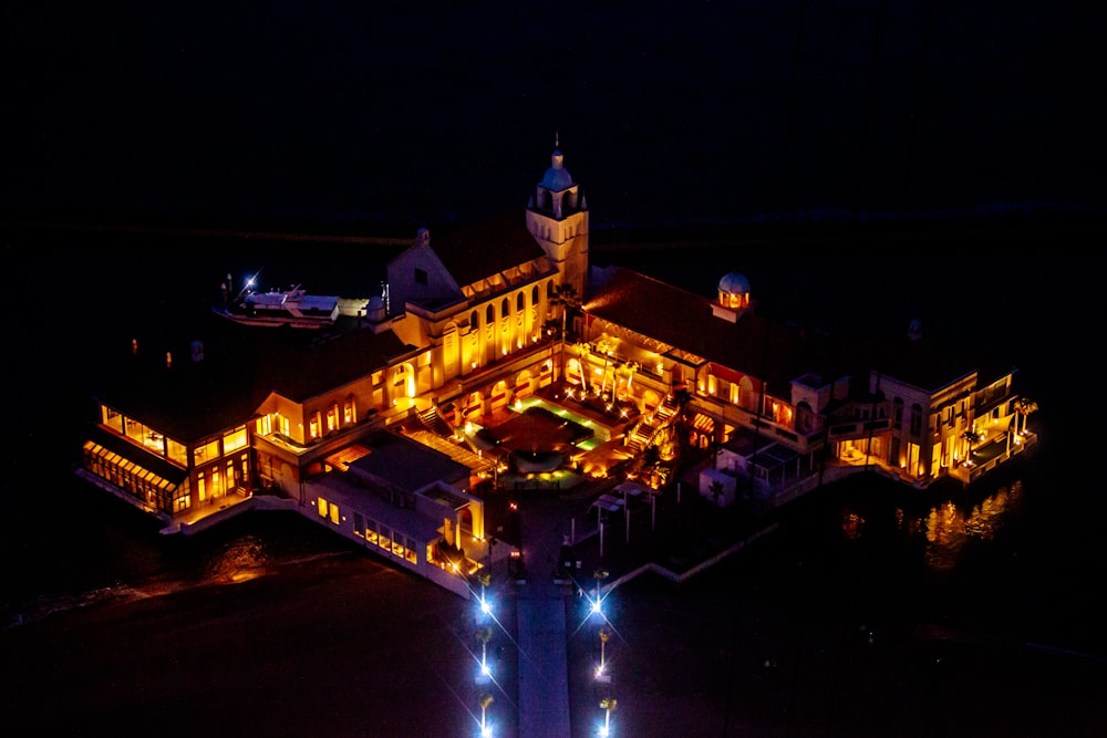 an aerial view of a building lit up at night