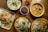 a wooden table topped with plates of food