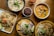 A beautifully arranged plate of colorful Thai dishes garnished with fresh herbs and vibrant vegetables.