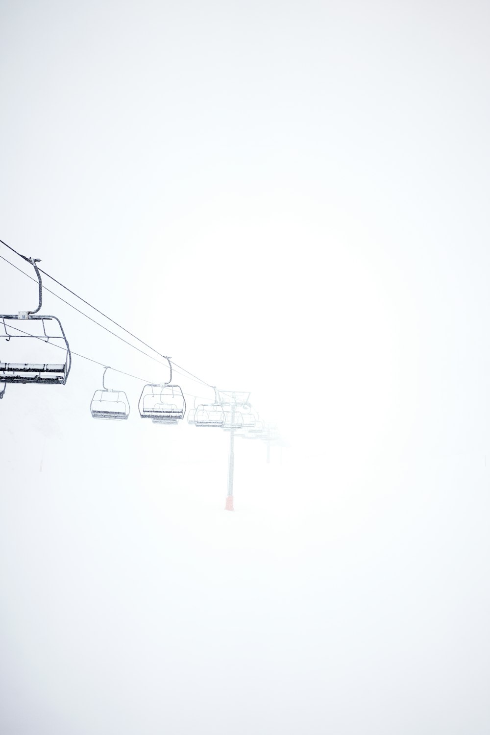 a ski lift going up a hill in the snow