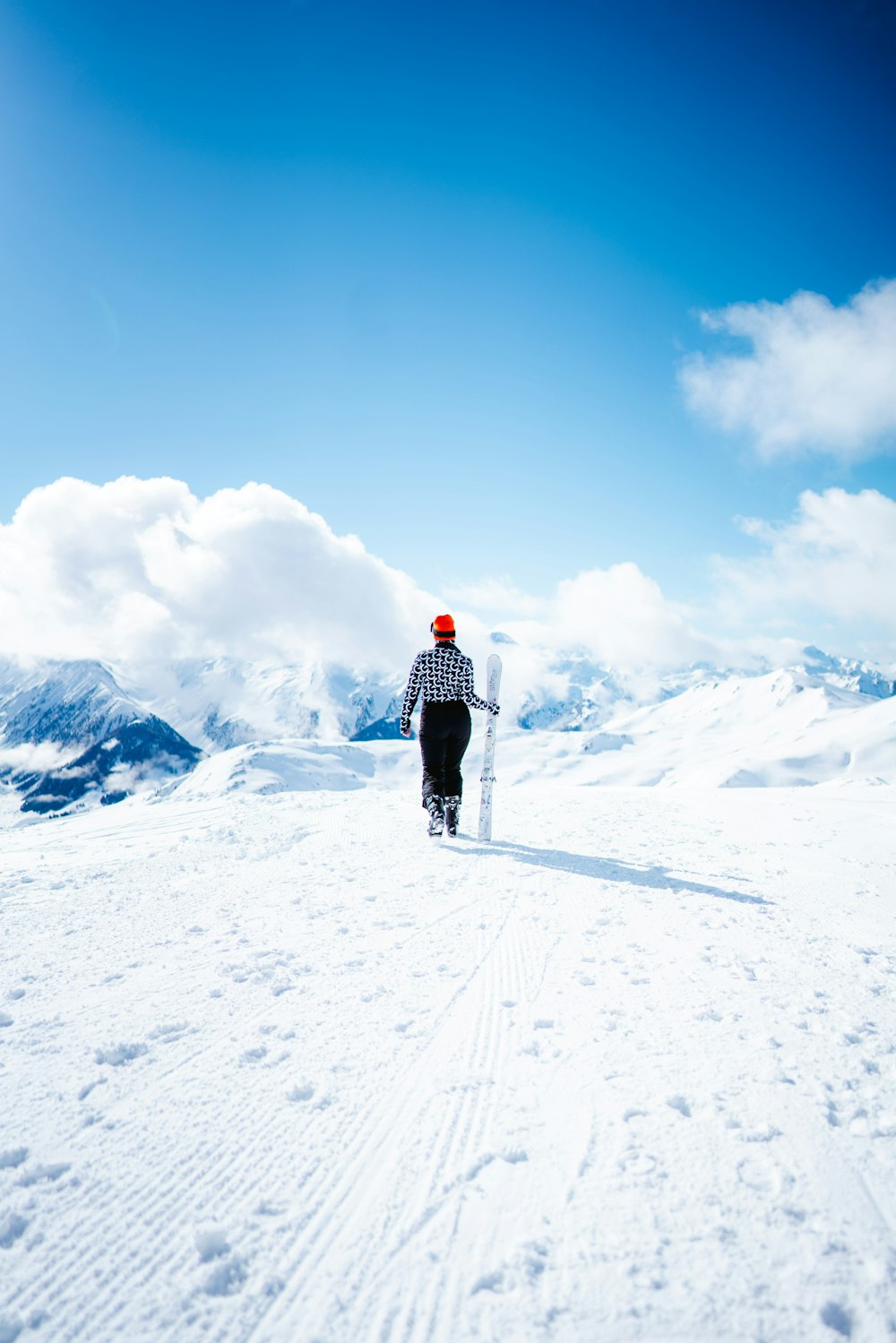 a person walking across a snow covered field