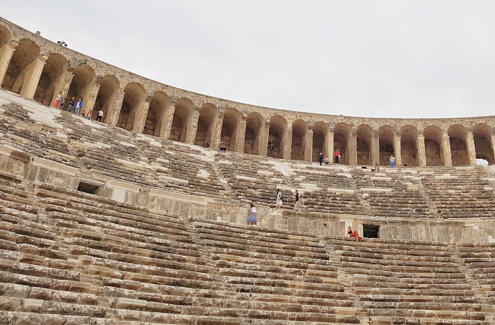 a group of people standing inside of a stone building