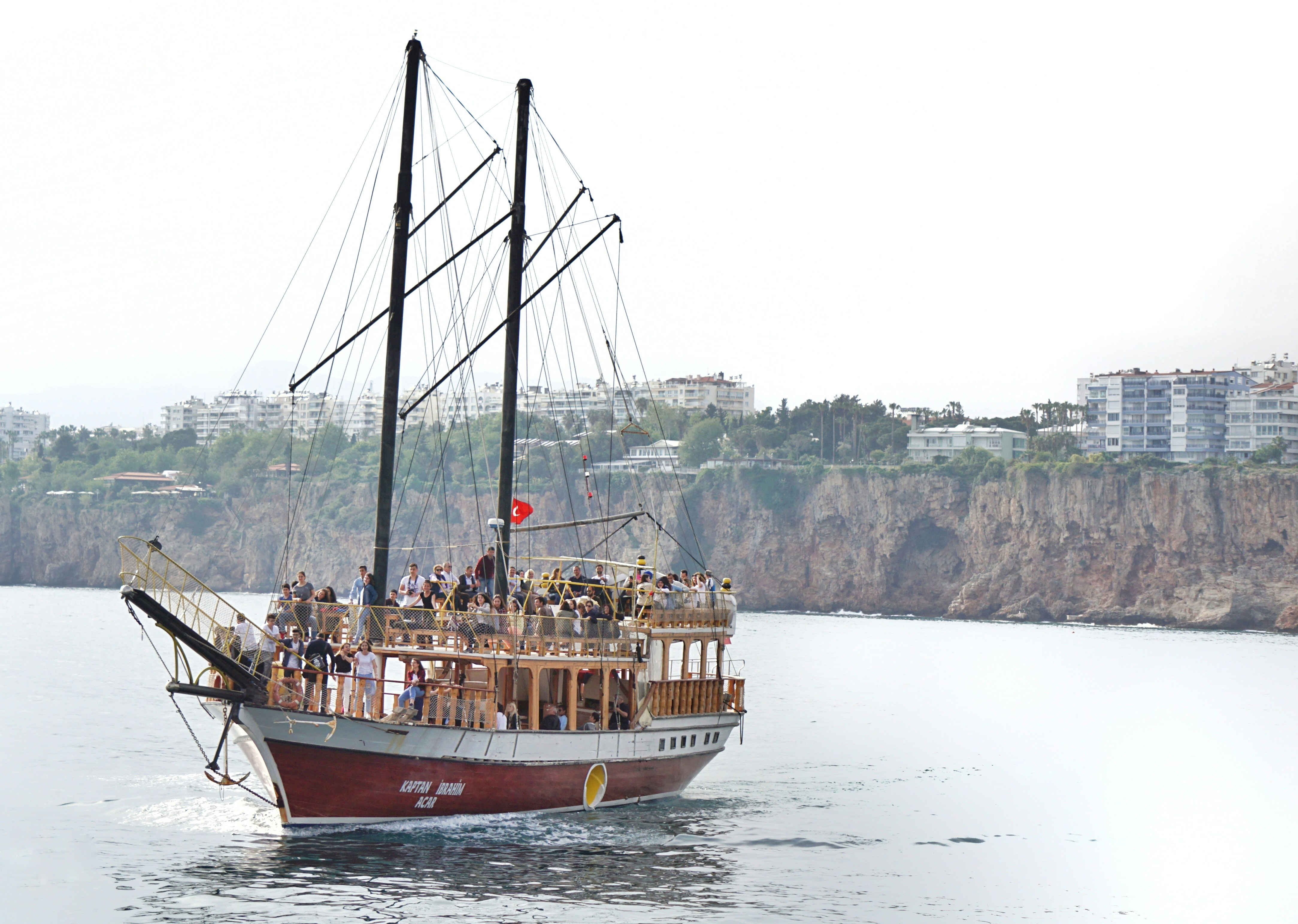 a boat full of people sailing on a body of water