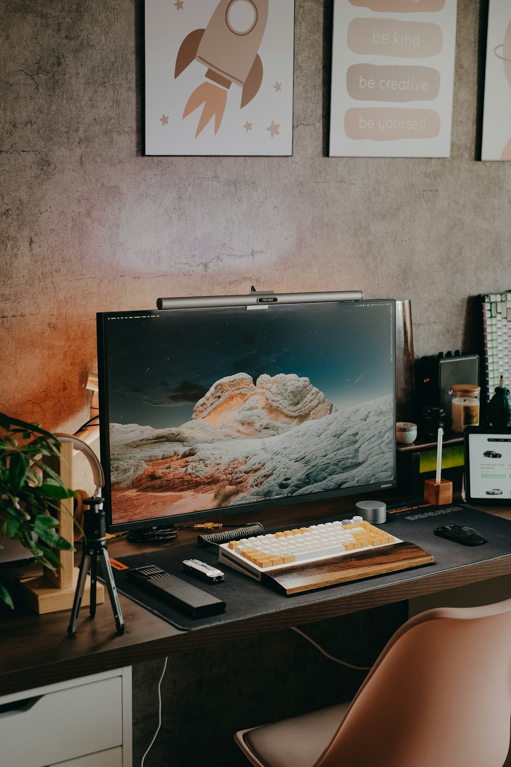 a desk with a computer monitor, keyboard and mouse