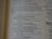 An open book with text on both visible pages, focusing on written content and paragraphs. The text includes religious or biblical references and verses can be identified.