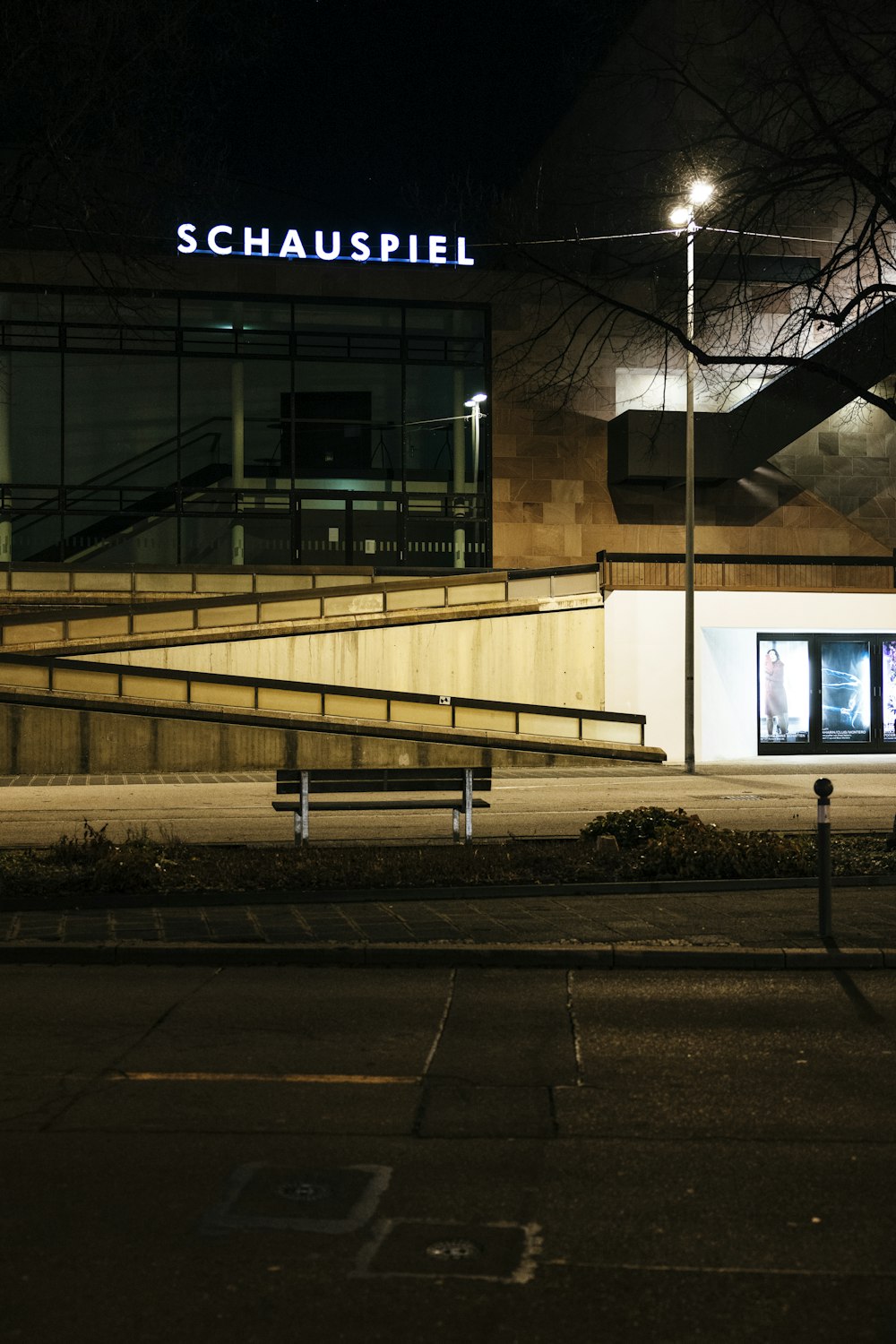 a building with stairs and a bench in front of it