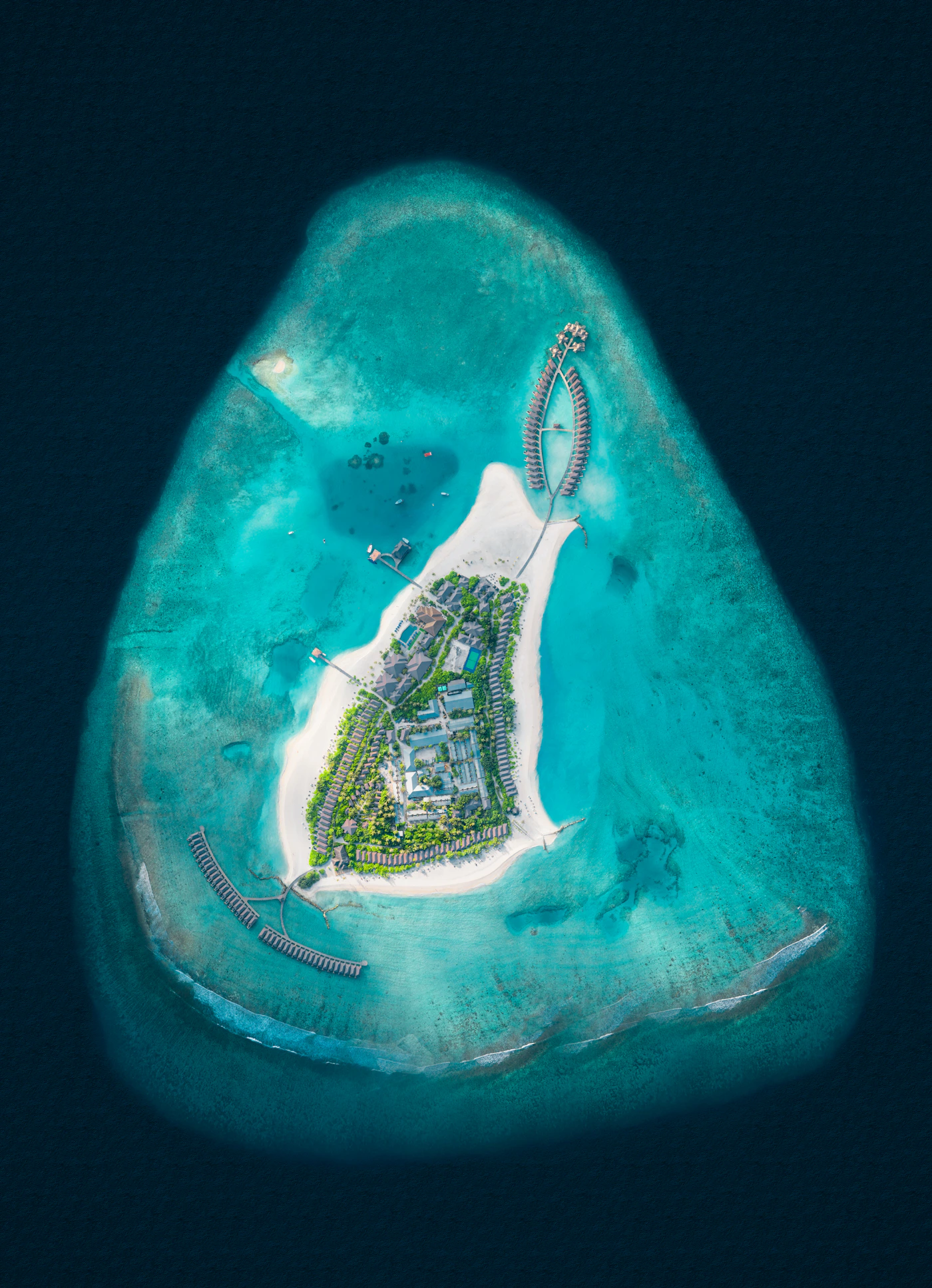 Aerial view of Brennia Kottefaru resort island and turquoise lagoon, Maldives