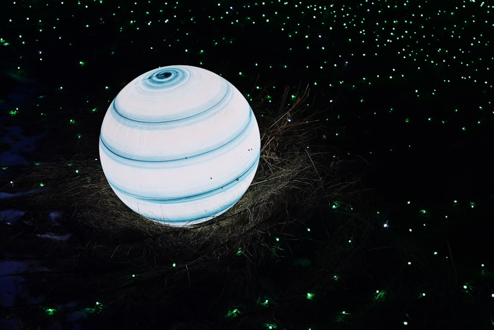 a large white ball sitting in the middle of a field