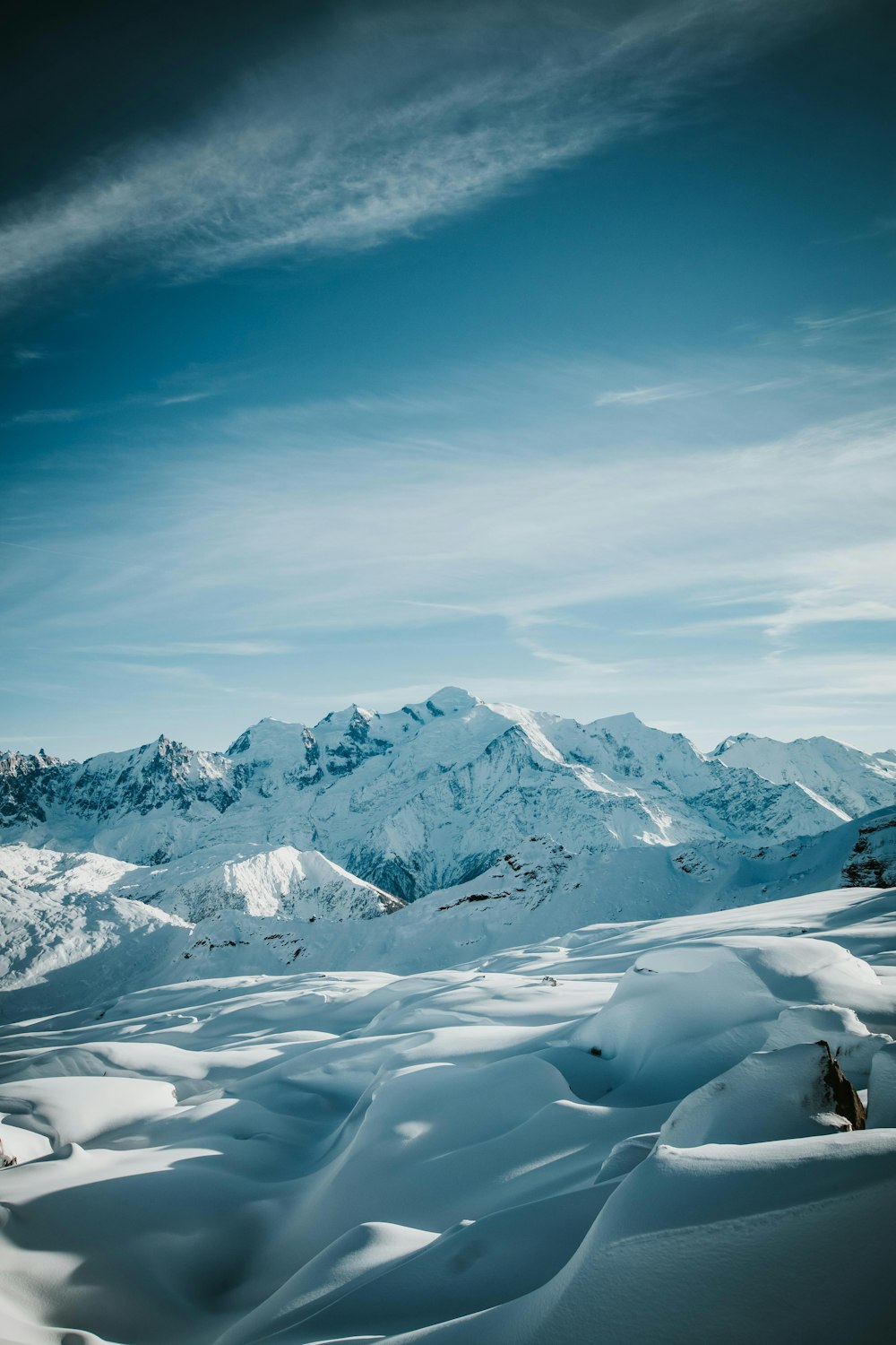 a person riding skis on top of a snow covered slope