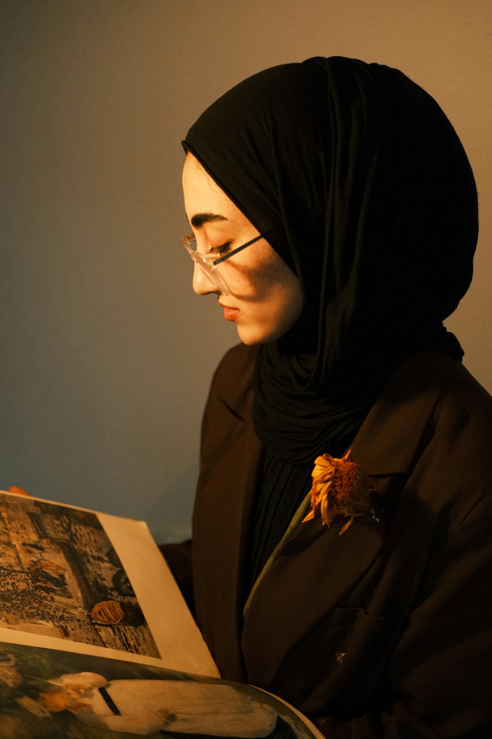 a woman in a headscarf reading a book