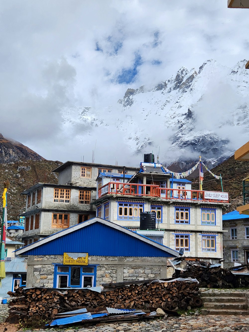 a blue and white building with a mountain in the background