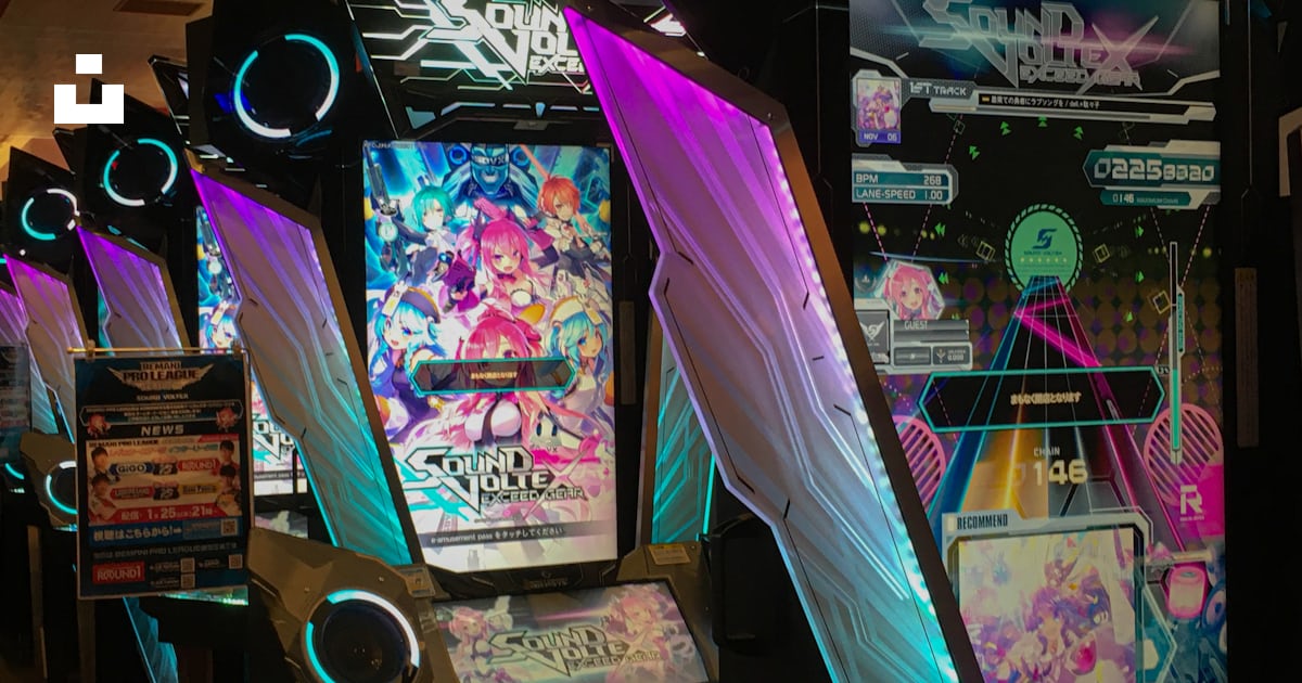A row of video game machines sitting next to each other photo – Free ...