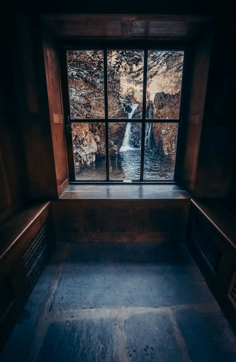 a window with a view of a waterfall