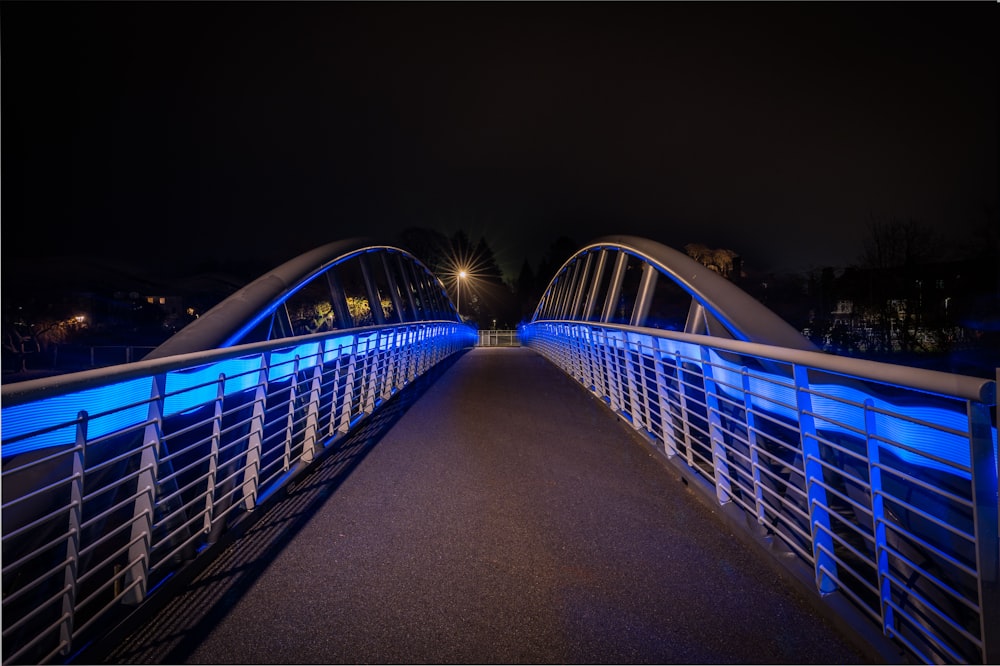 a bridge that is lit up with blue lights