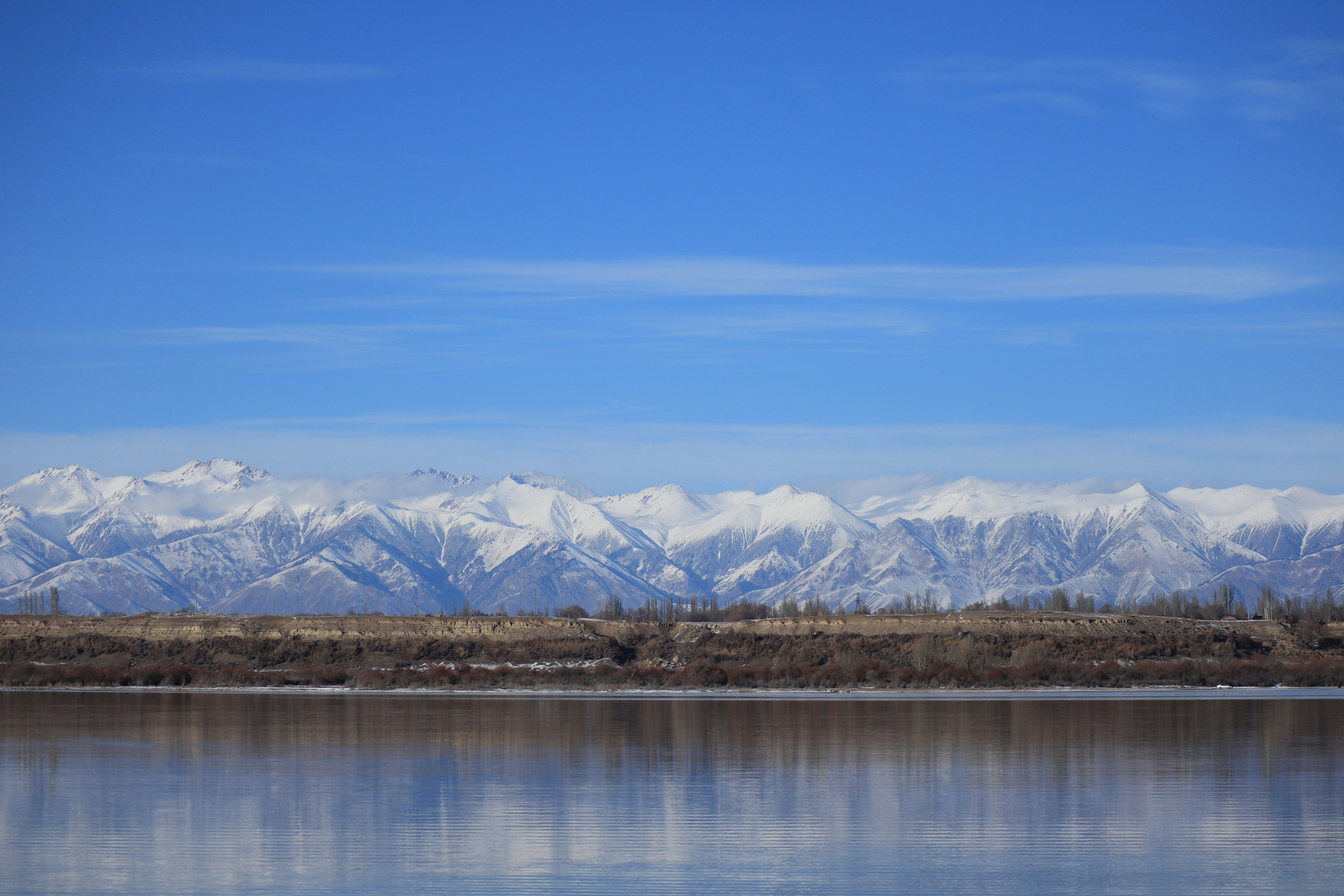a large body of water with mountains in the background