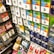 A display rack featuring a variety of gift and prepaid cards from popular brands. Cards are organized in stacks and rows, including Google Play, Apple iTunes, Amazon, PlayStation, Netflix, and more. The colors are vibrant and the packaging is clearly branded.