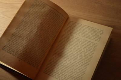 an open book sitting on top of a wooden table