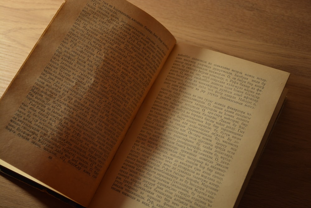 an open book sitting on top of a wooden table