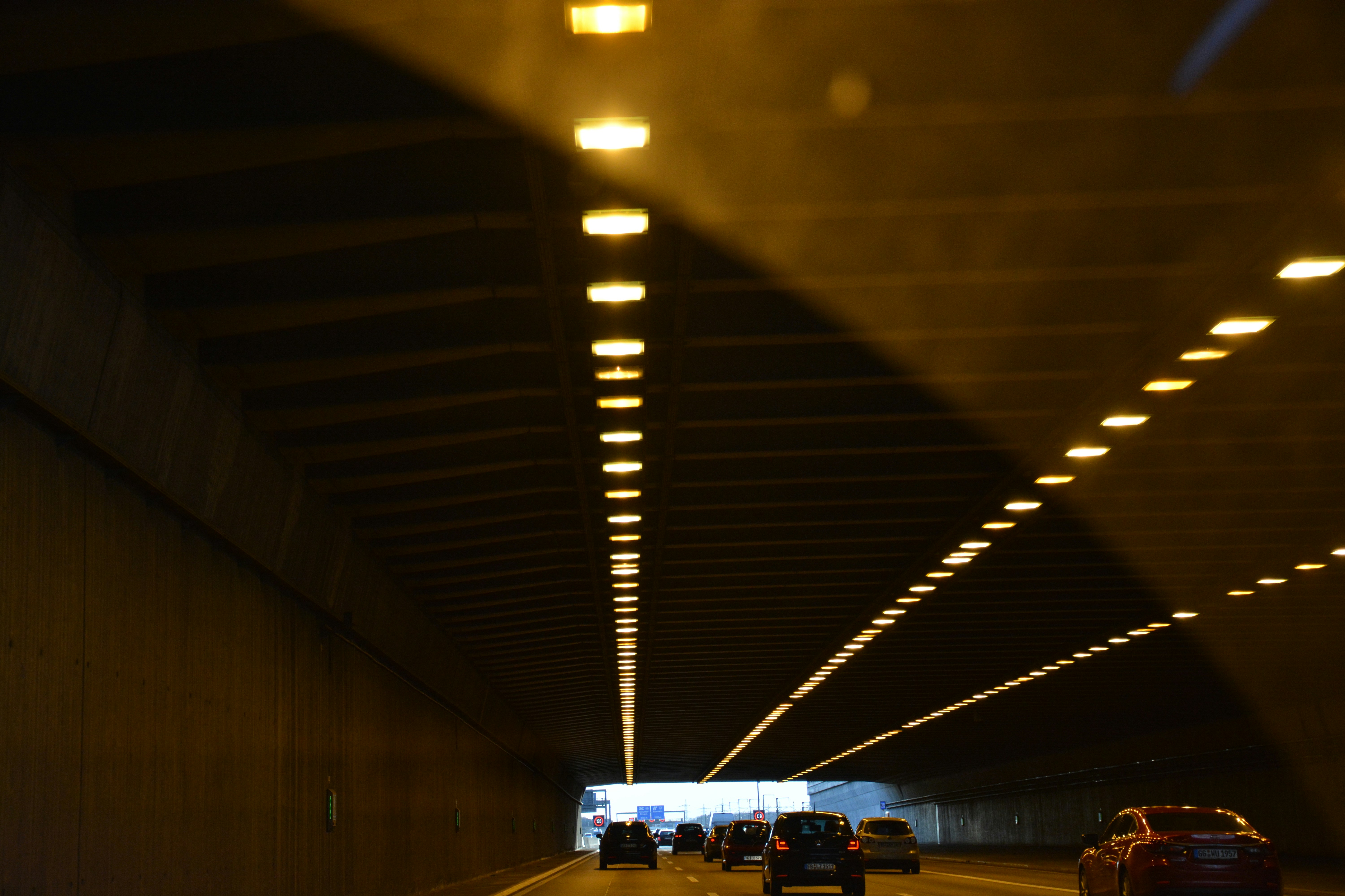 a car driving through a tunnel at night