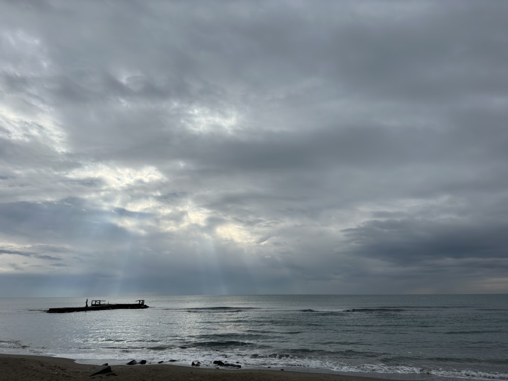 the sun shines through the clouds over the ocean