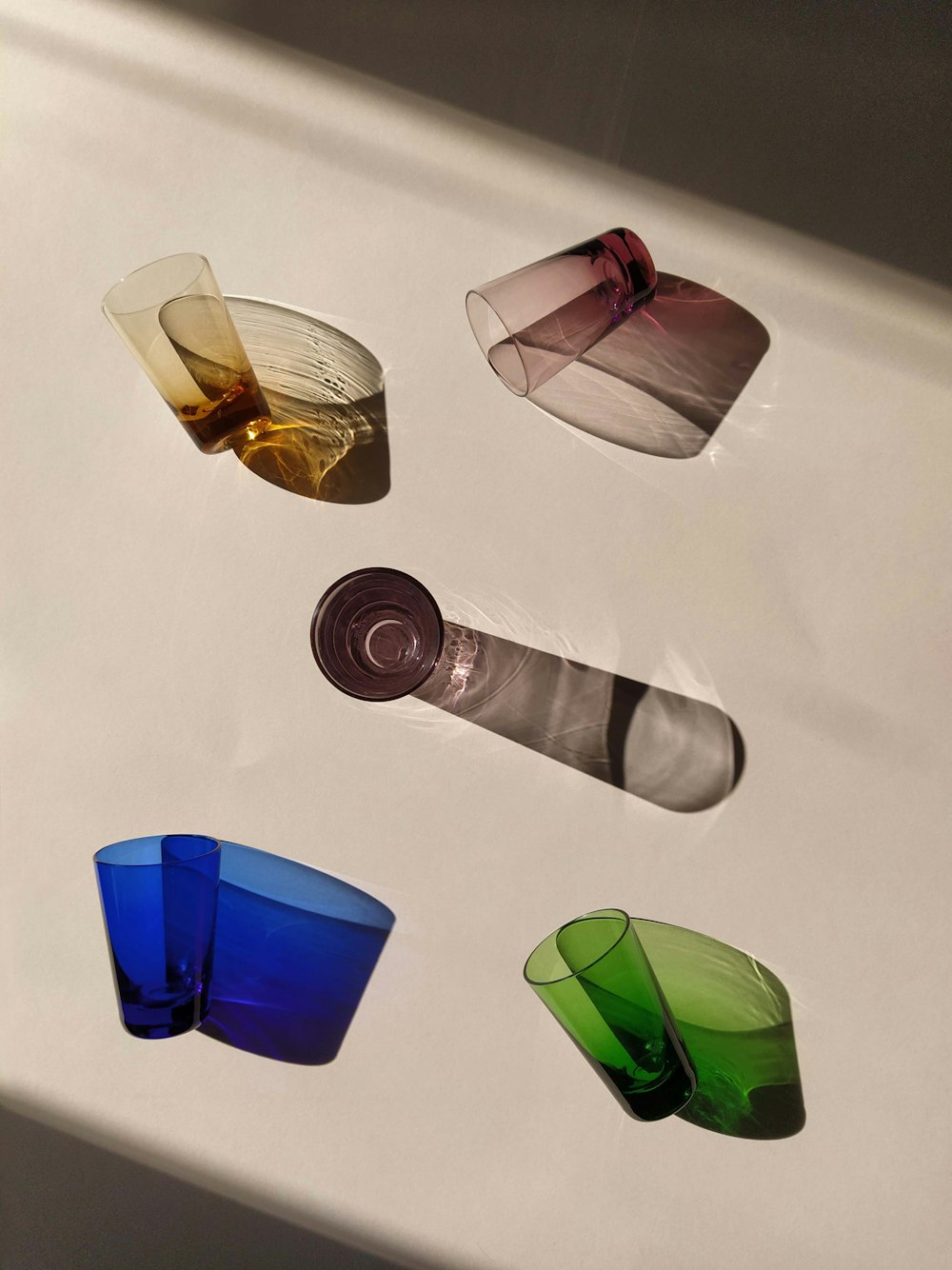 a group of different colored glasses sitting on top of a table