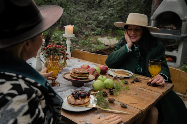 Lore and Jose enjoying breakfast outside the camper, surrounded by nature’s calm.
