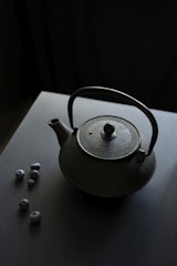 a teapot with a tea ball on a table