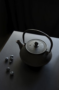 a teapot with a tea ball on a table