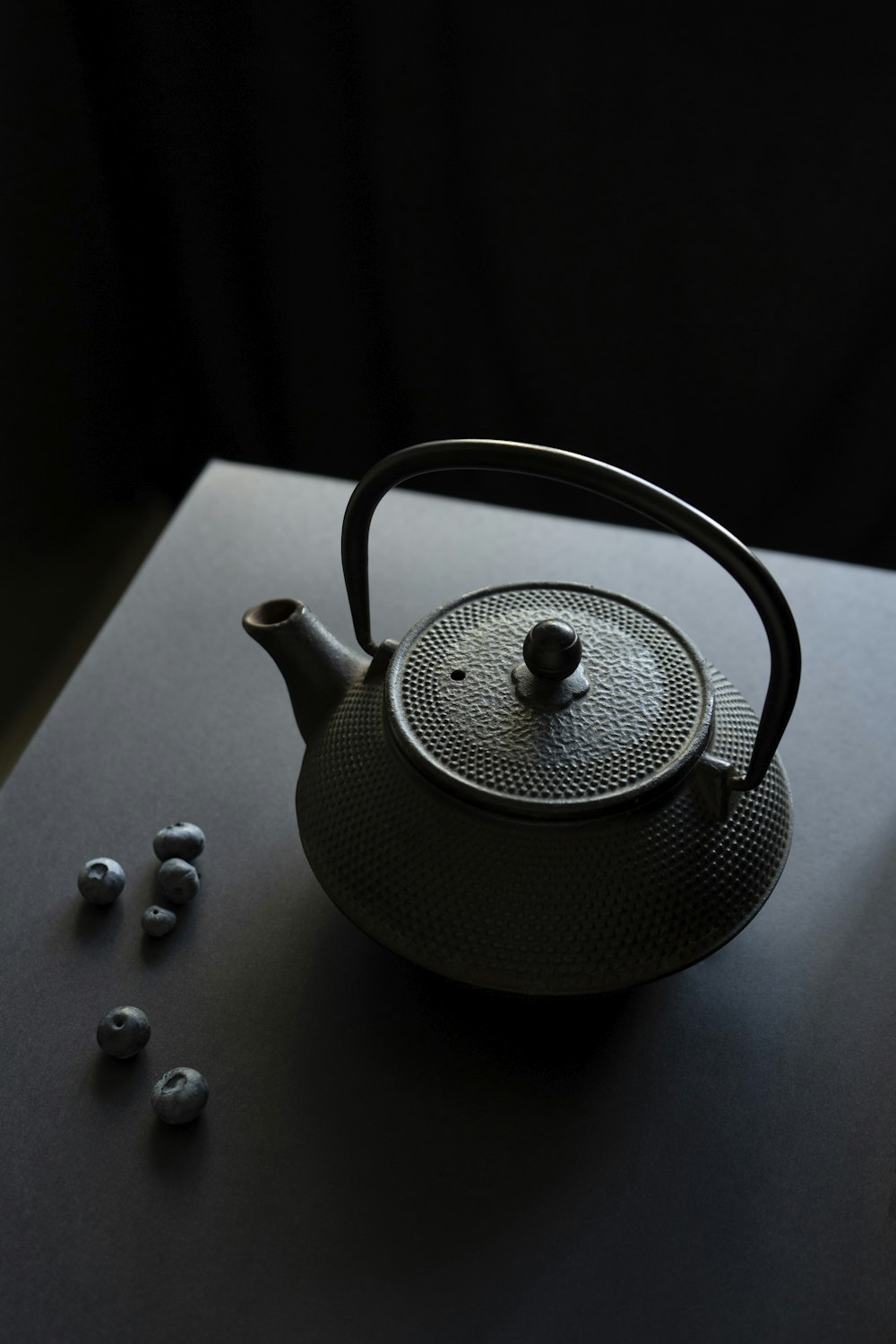 a teapot with a tea ball on a table
