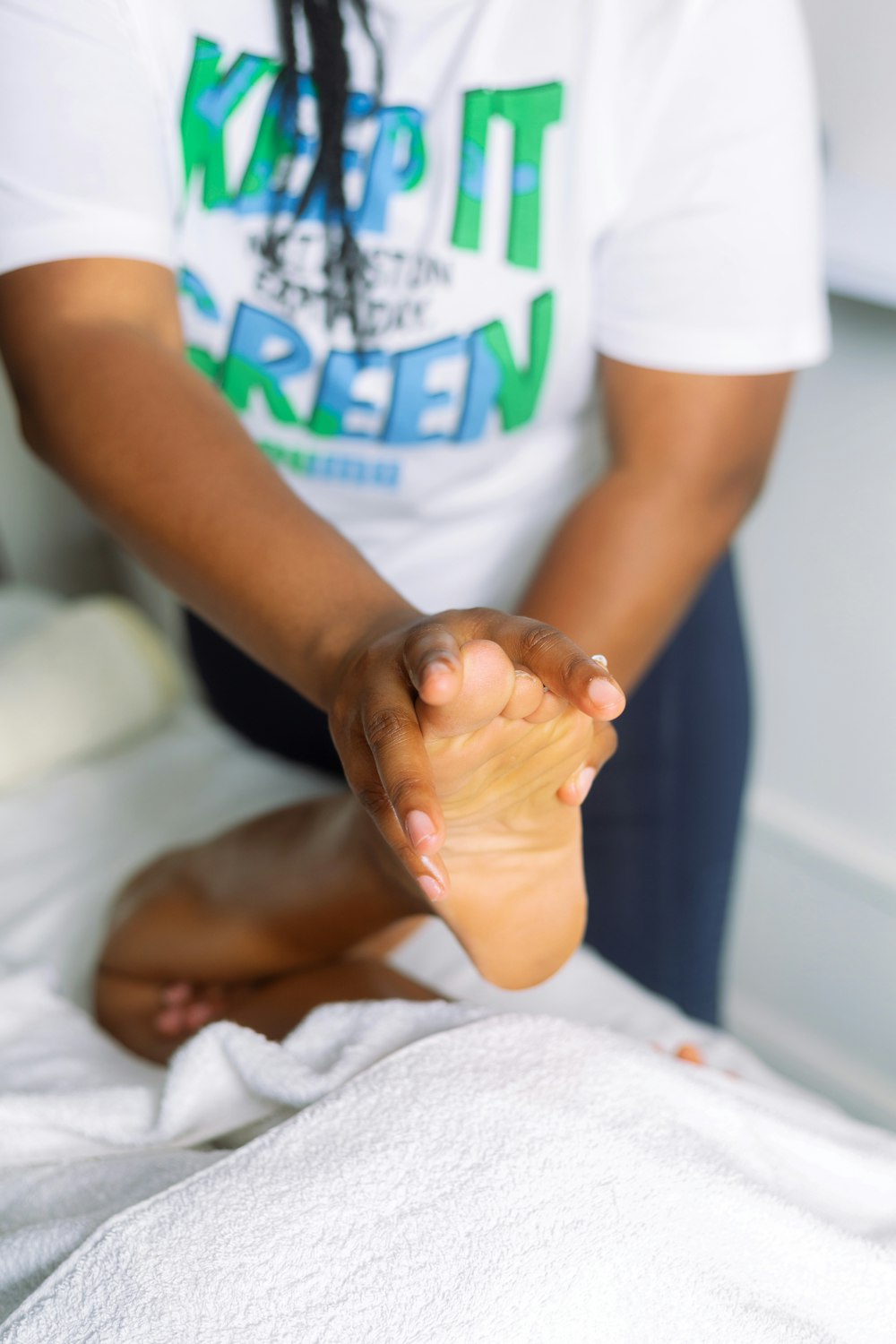 a person sitting on a bed with a foot in the air